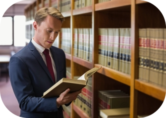 man looking at legal books about hypnosis