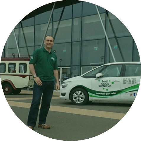 Hypnotist and Clinical Hypnotherapist Turan Mirza next to his hypnosis car